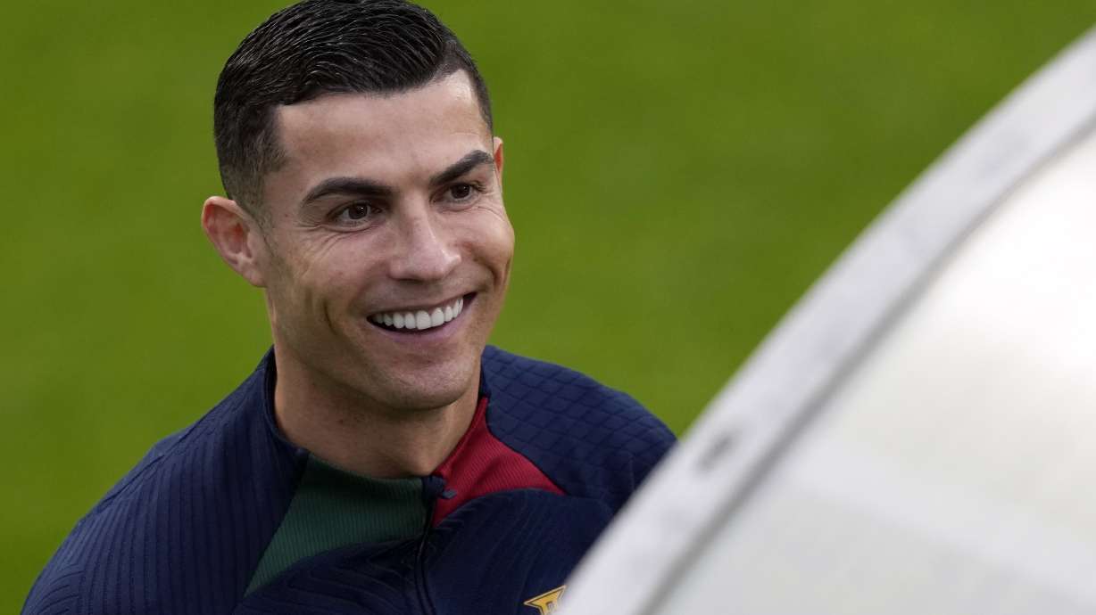 Cristiano Ronaldo smiles as he arrives for a Portugal soccer team training session in Oeiras, outside Lisbon, Monday, Nov. 14, 2022. Portugal will play Nigeria Thursday in a friendly match in Lisbon before departing to Qatar on Friday for the World Cup.