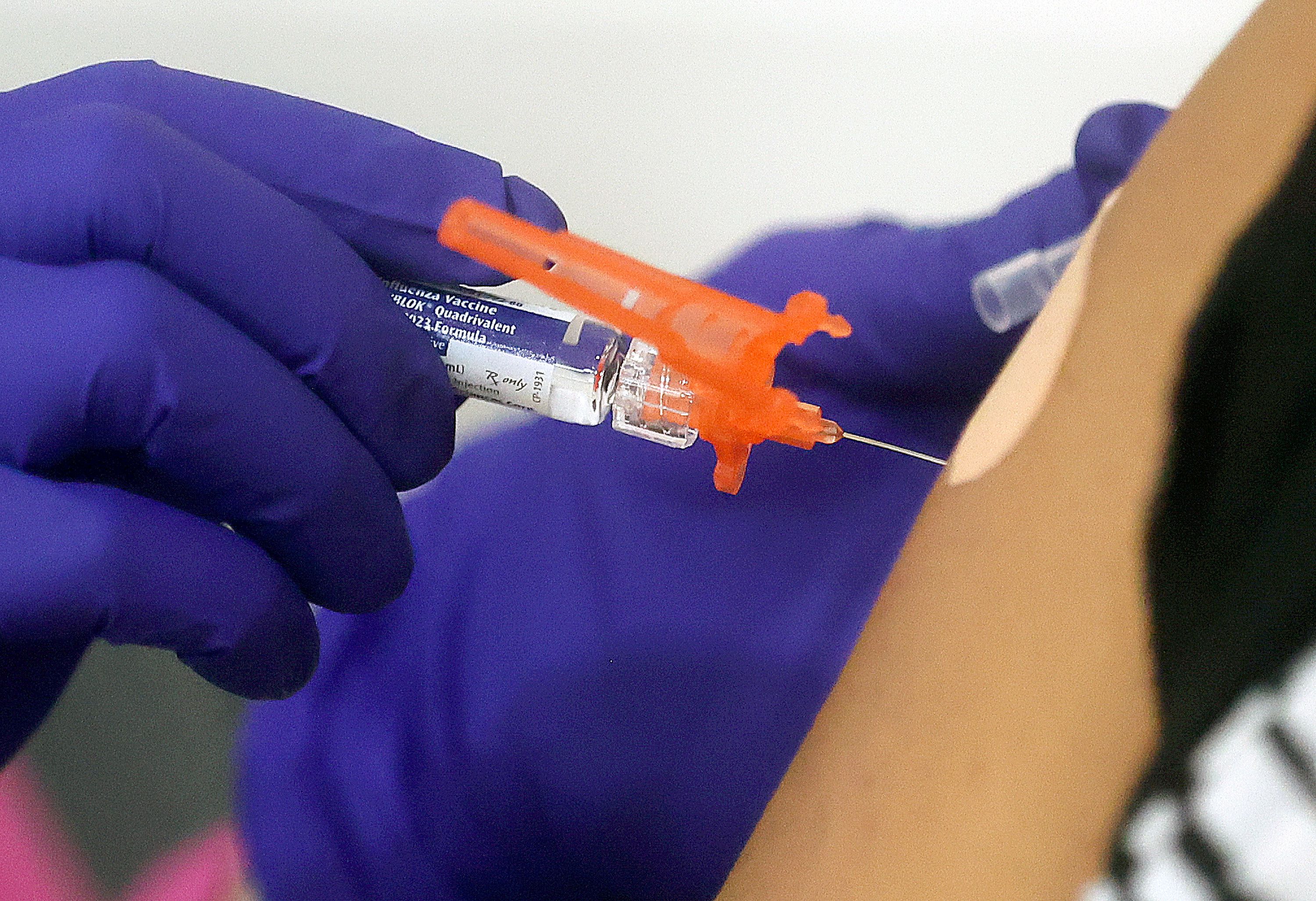 Jen Phung, a registered nurse with the Salt Lake County Health Department, administers a flu shot in Taylorsville on Nov. 9. What’s being called a “tripledemic” of respiratory viruses is hitting Utah and other parts of the country hard right now.