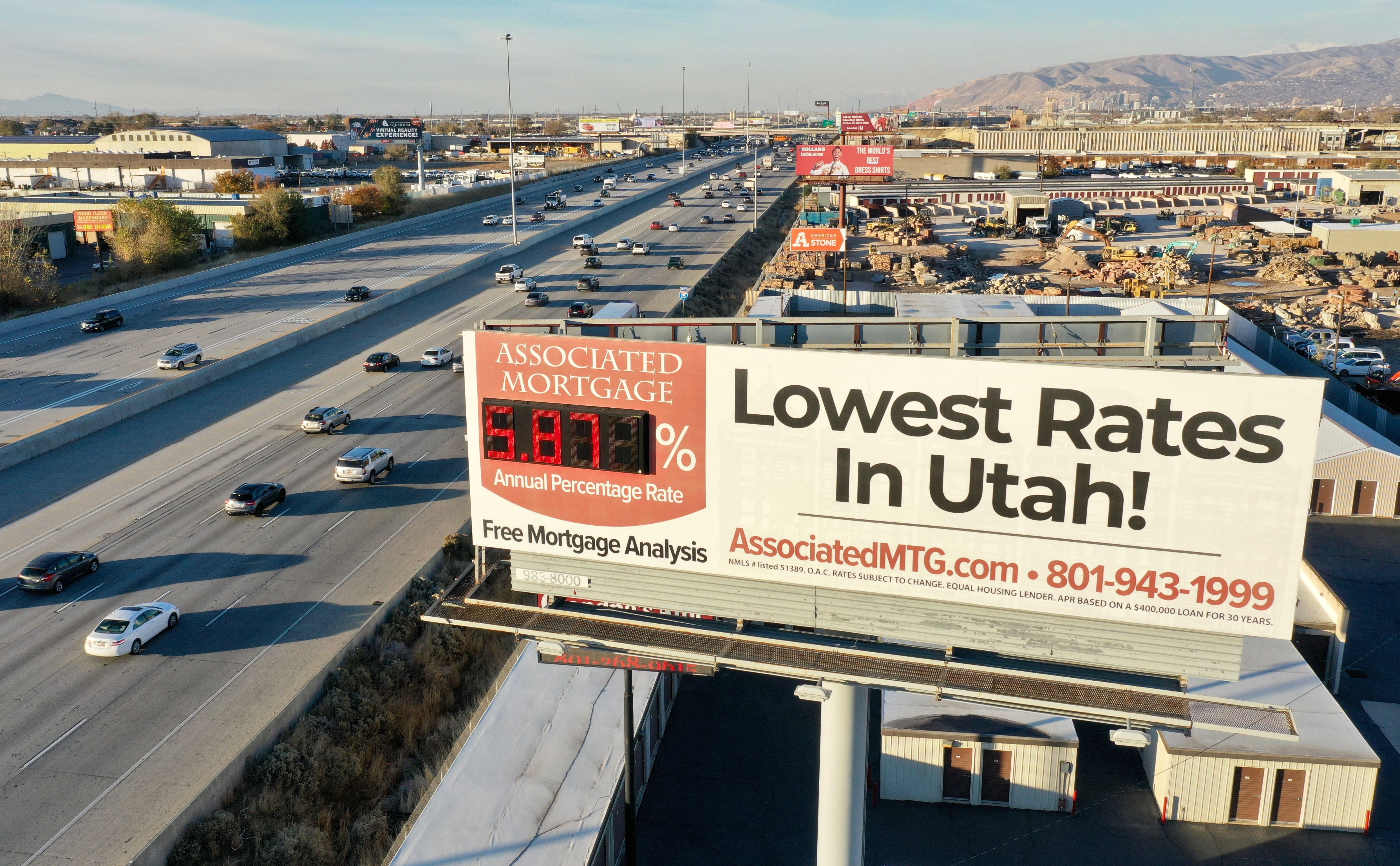 A billboard along I-15 advertises mortgage rates on Wednesday during rush hour in Murray. New reports find that U.S. consumers are showing no signs of backing off their ongoing penchant for robust spending but are, increasingly, covering their high roller habits with credit cards.