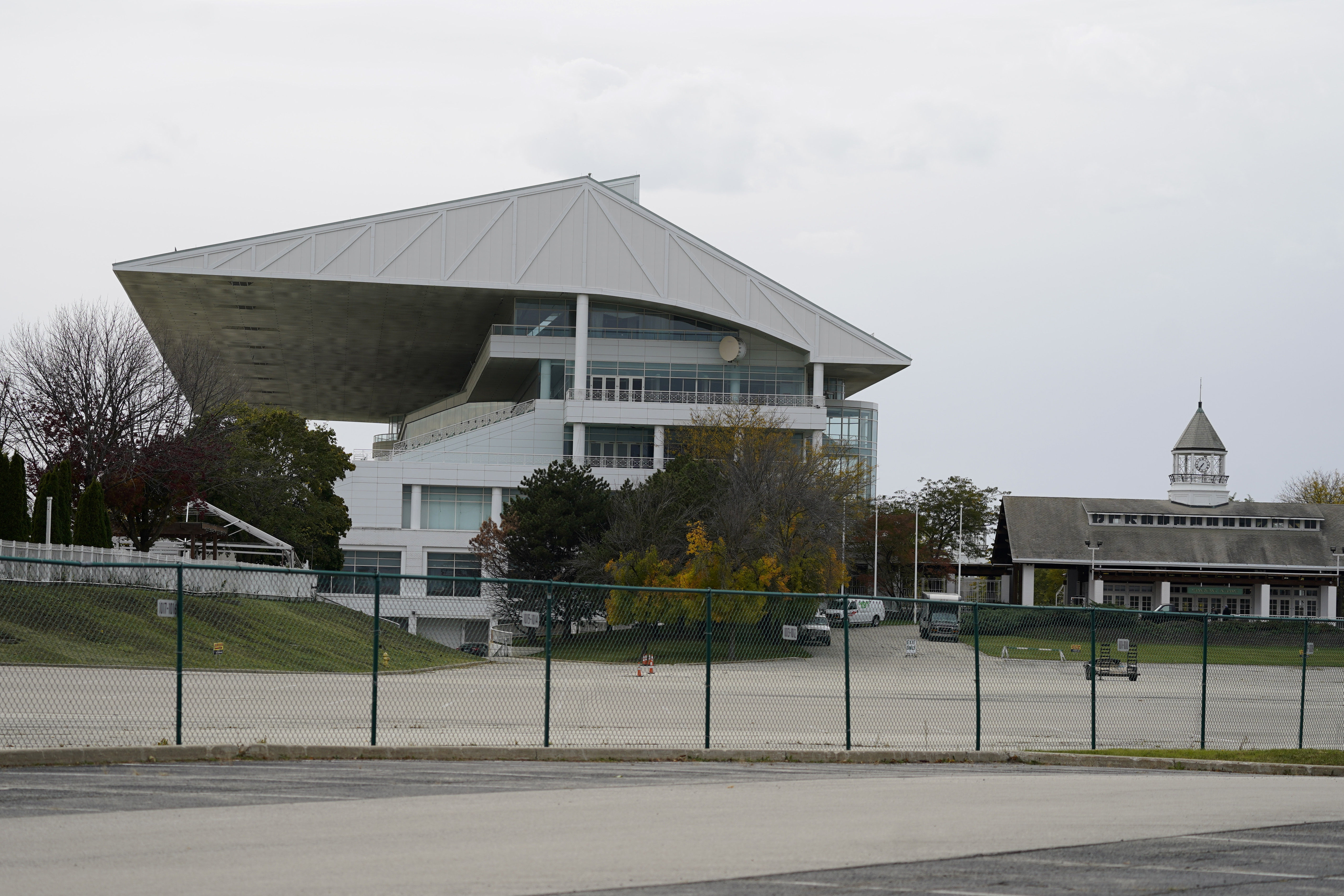 The grandstand at Arlington International Racecourse is seen from a parking lot in Arlington Heights, Ill., Friday, Oct. 14, 2022. The Chicago Bears want to turn the Arlington Heights site, once a jewel of thoroughbred racing, into a different kind of gem, anchored by an enclosed stadium and bursting with year-round activity — assuming a deal with Churchill Downs Inc. to buy the land goes through. They envision restaurants, retail and more on the plot of land some 30 miles northwest of their longtime home at Soldier Field — all for about $5 billion, with some taxpayer help.