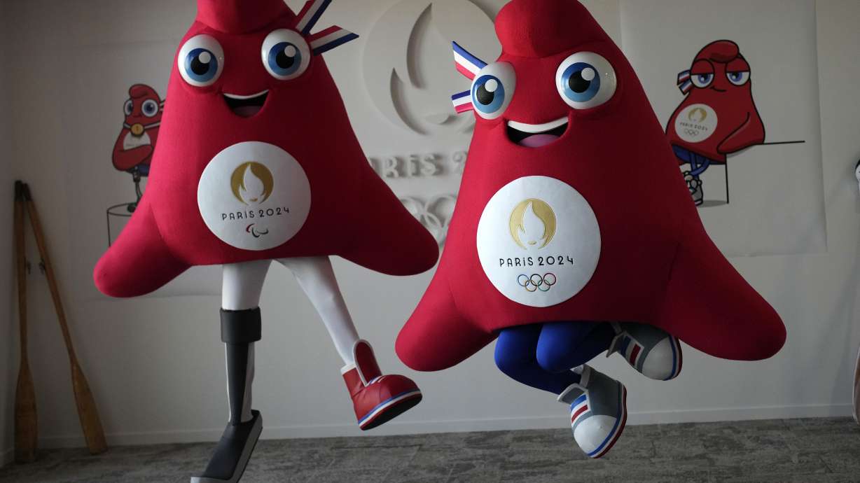 FILE - Mascots of the 2024 Paris Olympic Games, right, and Paralympics Games, a Phrygian cap, jump during a preview in Saint Denis, outside Paris, on Thursday, Nov. 10, 2022. Izzy, the much-hated blob that represented the 1996 Atlanta Games has been supplanted by the mascot for the Paris Olympics — a Phrygian cap.