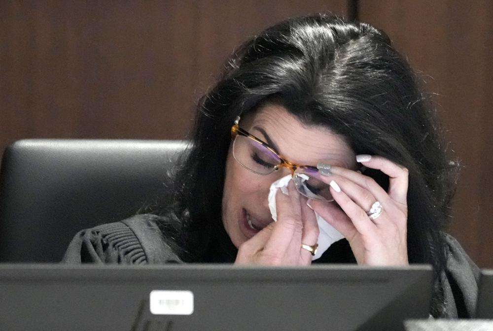 Waukesha County Circuit Court Judge Jennifer Dorow wipes away tears while talking about victim statements during her closing remarks before sentencing Darrell Brooks to 6 consecutive life sentences in a Waukesha County Circuit Court in Waukesha, Wis., on Wednesday.