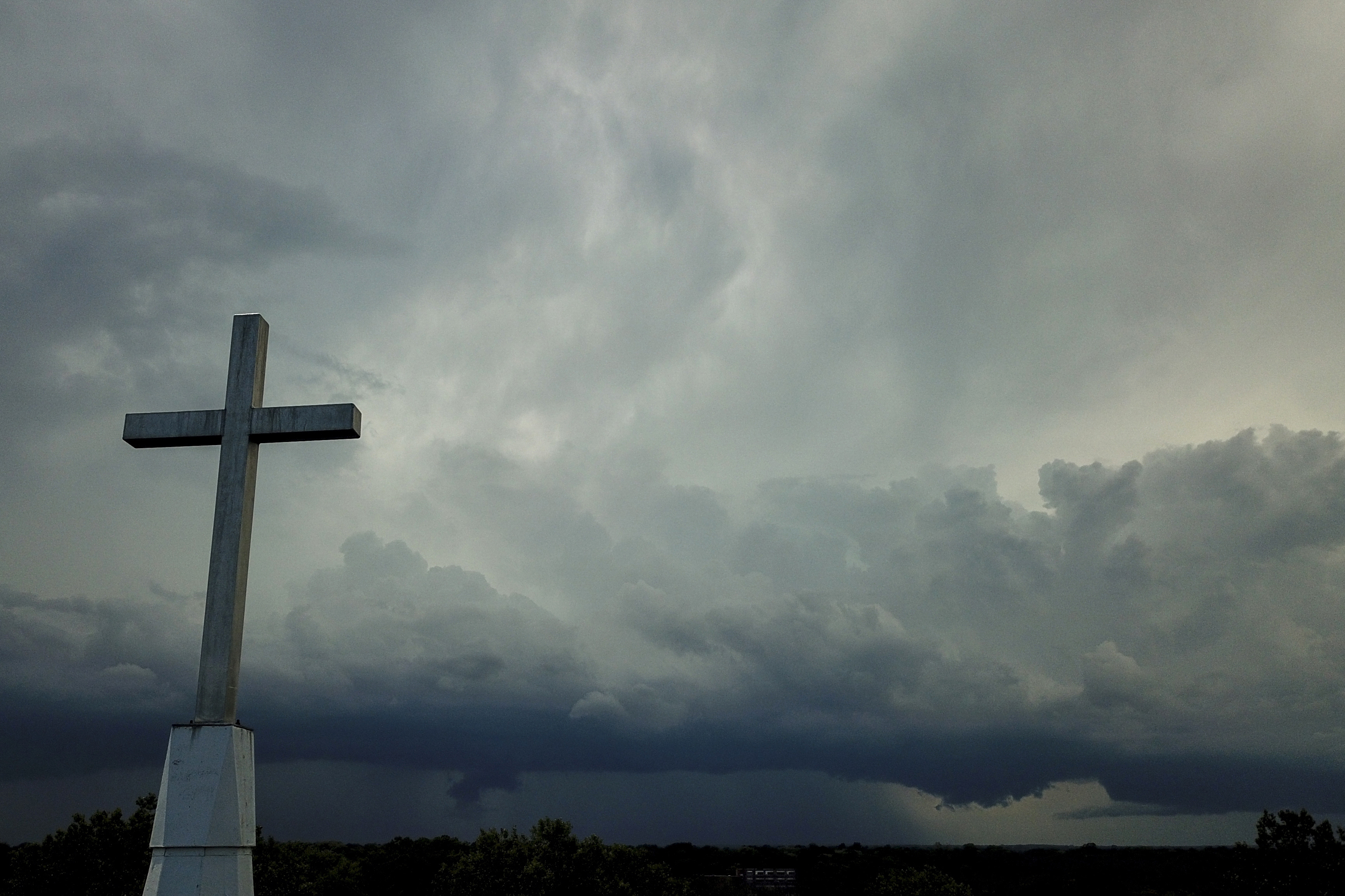 Storm clouds approach a church in Mequon, Wis., on Aug. 2, 2020. A new Pew Research Center report published Thursday explores how religion in the U.S. intersects with views on the environment and climate change. 