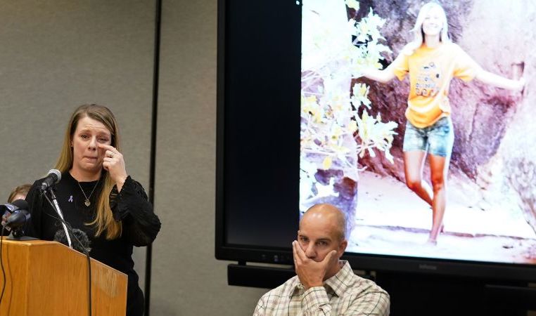 Gabby Petito's mother, Nichole Schmidt, speaks during a news conference as her husband, Jim Schmidt, looks on Nov. 3 in Salt Lake City. The families of Petito and Brian Laundrie have reached a $3 million settlement in a wrongful death lawsuit filed after authorities concluded he strangled her during a cross-country trip in August 2021.