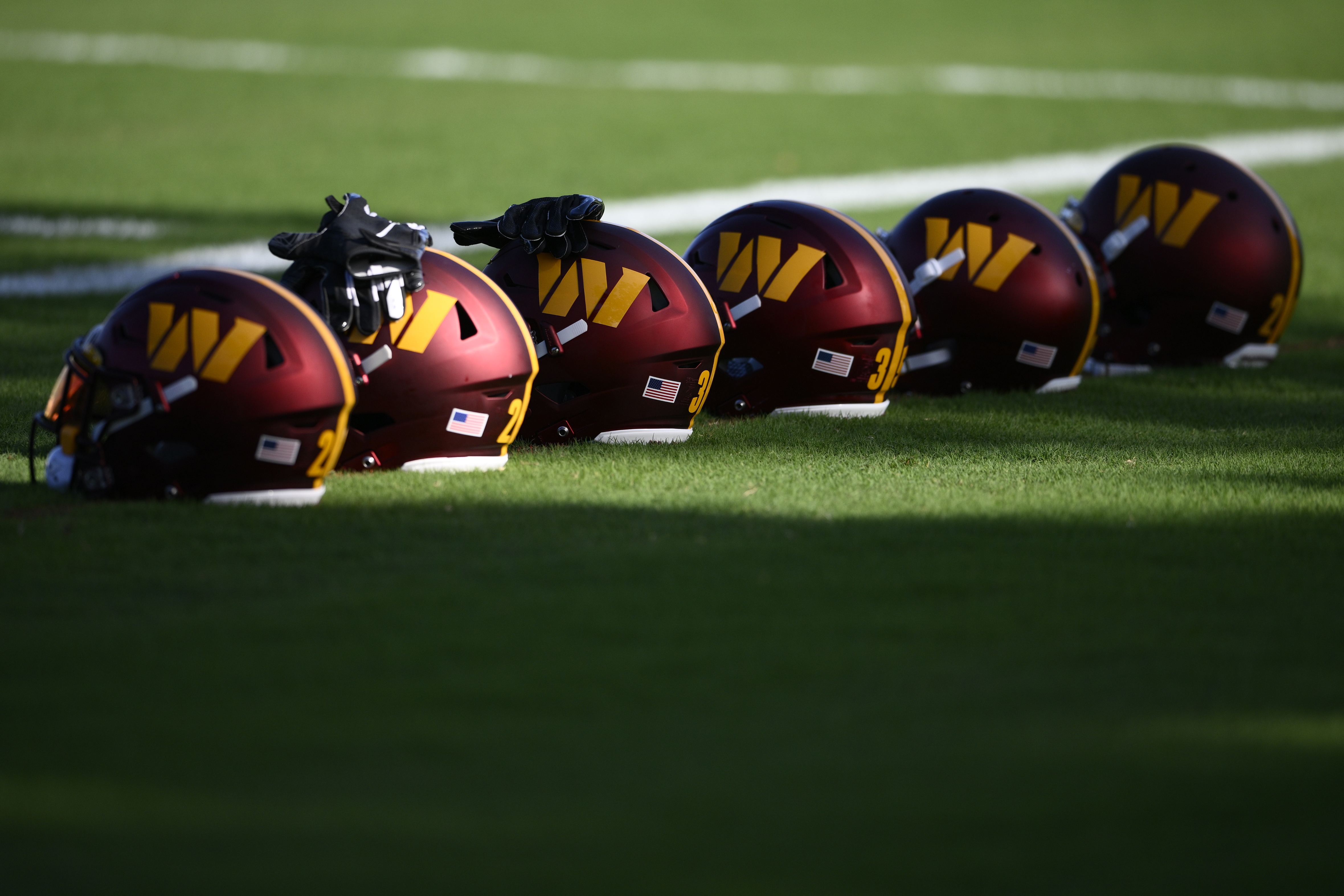 FILE- Washington Commanders helmets sit on the field during practice at the team's NFL football training facility, Monday, Aug. 1, 2022 in Ashburn, Va. The congressional investigation of the NFL's Washington Commanders will end when Republicans take over early next year. U.S. House Committee for Oversight and Reform ranking Republican Rep. James Comer issued a statement Thursday, Nov. 17, 2022, saying simply, ‘It’s over."