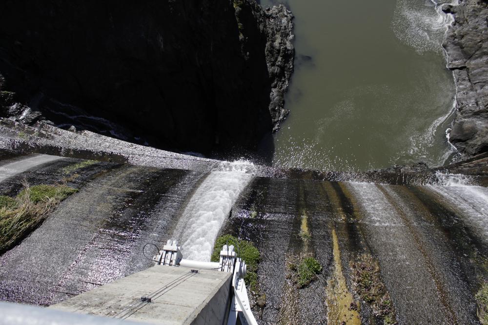 Excess water spills over the top of a dam on the Lower Klamath River known as Copco 1 near Hornbrook, Calif., on March 3, 2020. Plans for the largest dam demolition project in U.S. history to save imperiled salmon could soon become reality, with the first stages of construction starting in California as early as this summer. The Federal Energy Regulatory Commission meets to discuss plans Thursday.