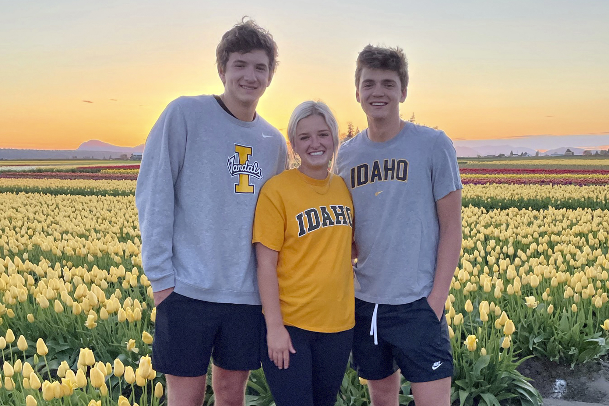 Triplets Ethan, Maizie and Hunter Chapin pose in front of a tulip field in La Conner, Wash., in April of 2021. Ethan Chapin was one of four University of Idaho students found stabbed to death in a home near the Moscow, Idaho campus on Sunday.