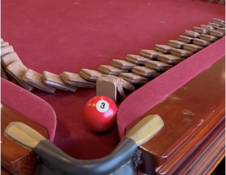 Australian brothers Thomas and Jonathan have come up with creative ways to pass each other chocolate Tim Tams to dip into their glasses of milk.