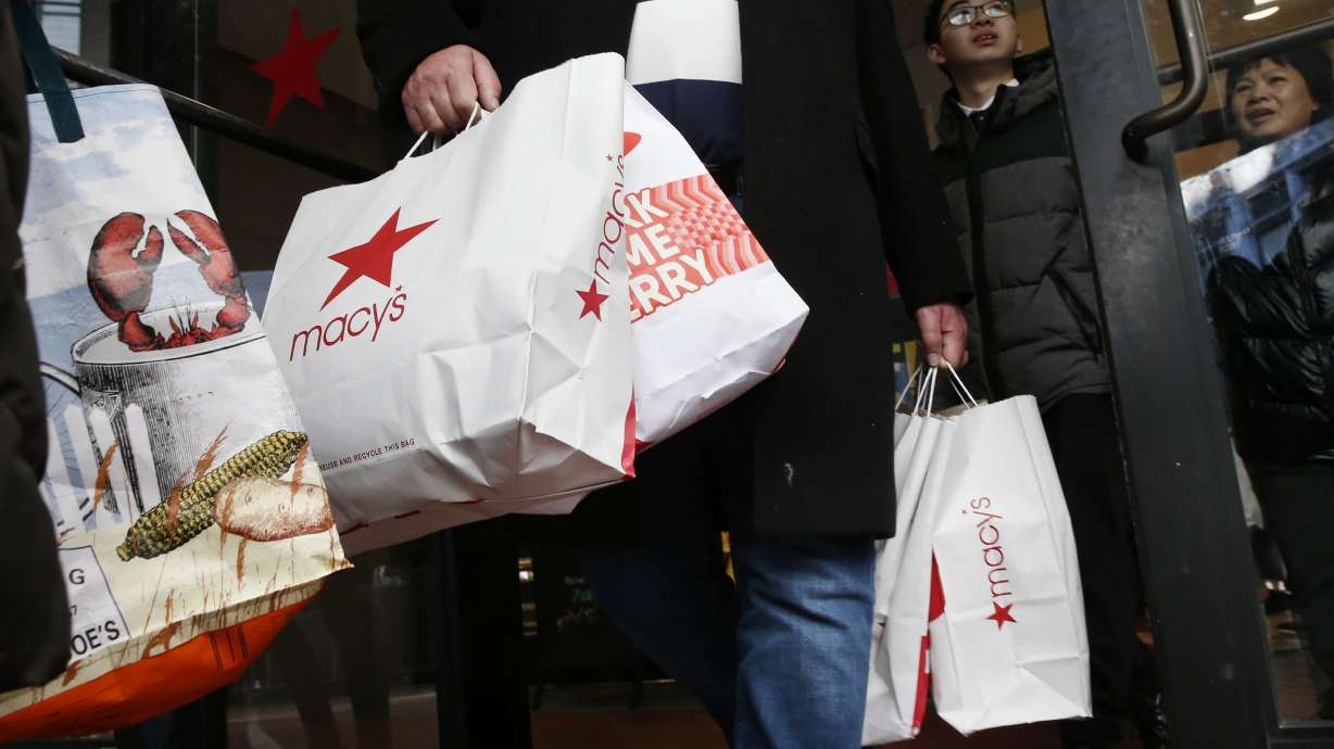 Black Friday shoppers leave Macy’s in Boston on Nov. 29, 2019. Some store-branded retail credit cards have increased their interest rates significantly.