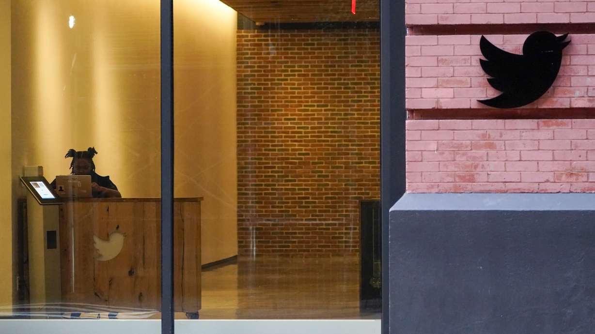 A receptionist works in the lobby of the building that houses the Twitter office in New York, Oct. 26. On Thursday,Twitter continued to bleed engineers and other workers after new owner Elon Musk gave them a choice to pledge to “hardcore” work or resign with severance pay.