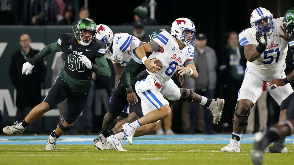 Southern Methodist quarterback Tanner Mordecai (8) scrambles under pressure from Tulane linebacker Devean Deal (90) during the first half of an NCAA college football game in New Orleans, Thursday, Nov. 17, 2022.