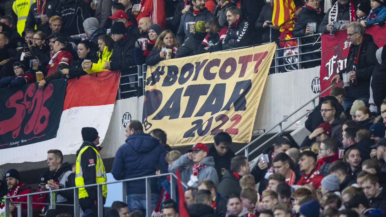 A placard with the inscription "Boycott Qatar 2022" can be seen in the SC Freiburg fan block before the Bundesliga soccer match between Freiburg and FC Union Berlin at Europa-Park Stadion in Freiburg im Breisgau, Germany, Sunday, Nov. 13, 2022. .