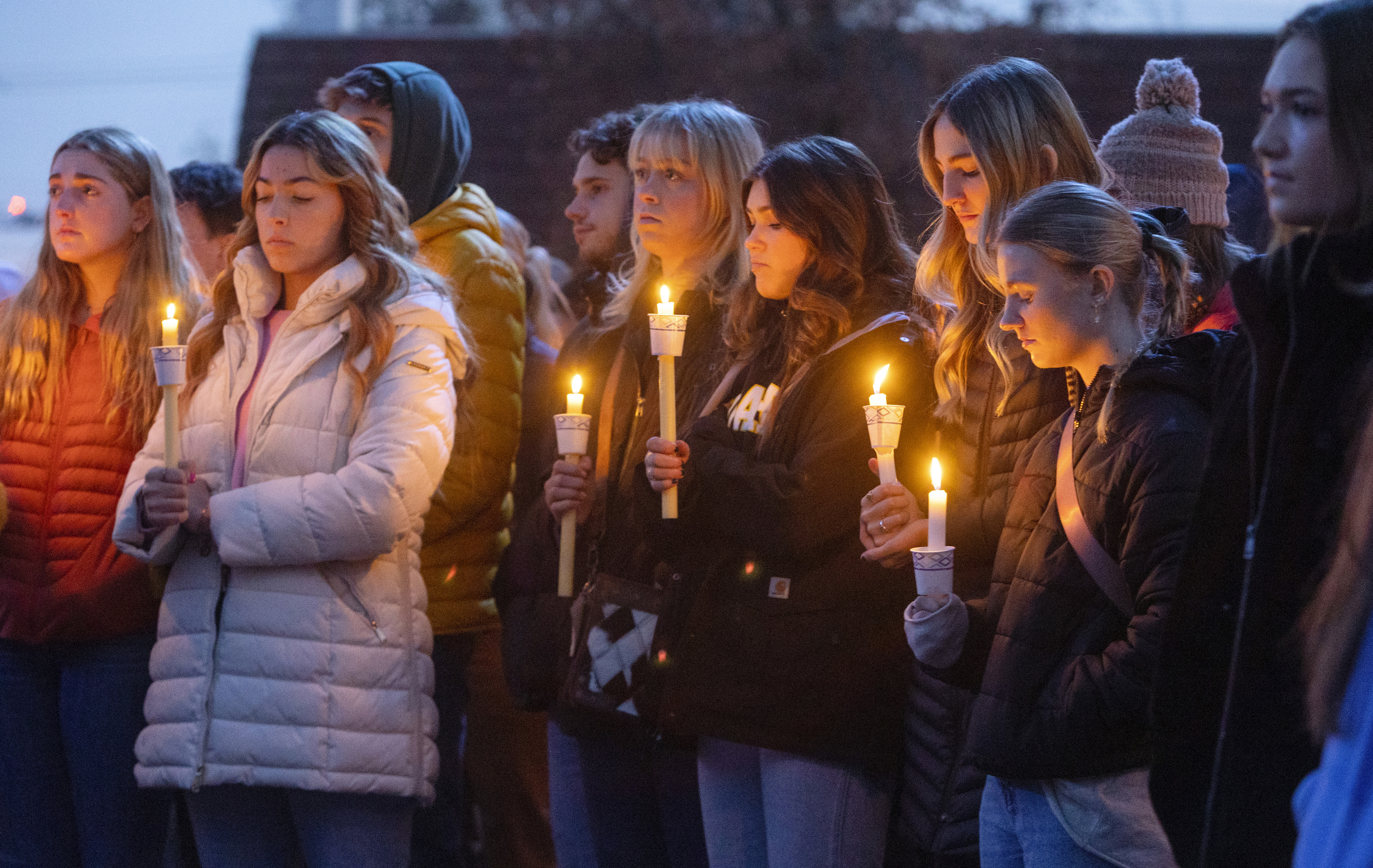 Boise State University students, along with people who knew the four University of Idaho students who were found killed in Moscow, Idaho, days earlier, pay their respects at a vigil held in front of a statue on the Boise State campus, Thursday, in Boise, Idaho.