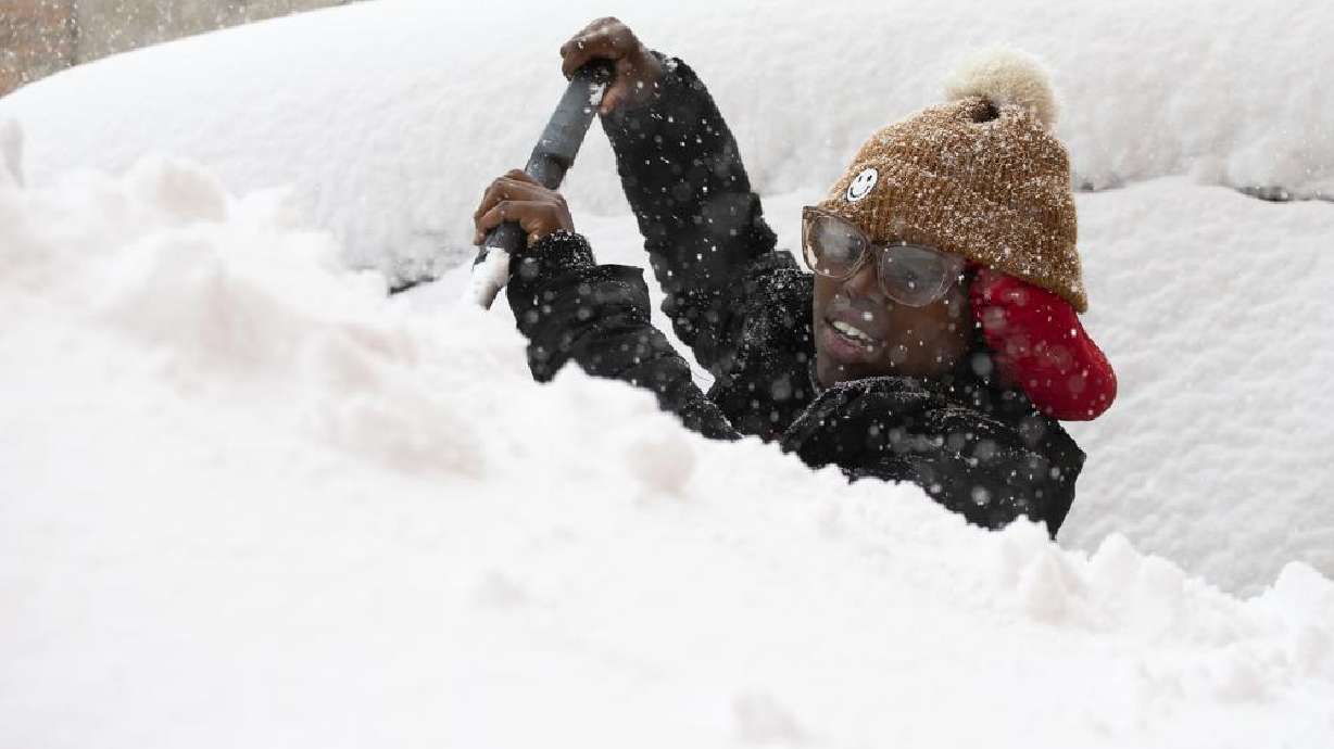 Zaria Black, 24, from Buffalo, clears off her car as snow falls Friday in Buffalo, N.Y. A dangerous lake-effect snowstorm paralyzed parts of western and northern New York, with nearly two feet of snow already on the ground in some places and possibly much more on the way.