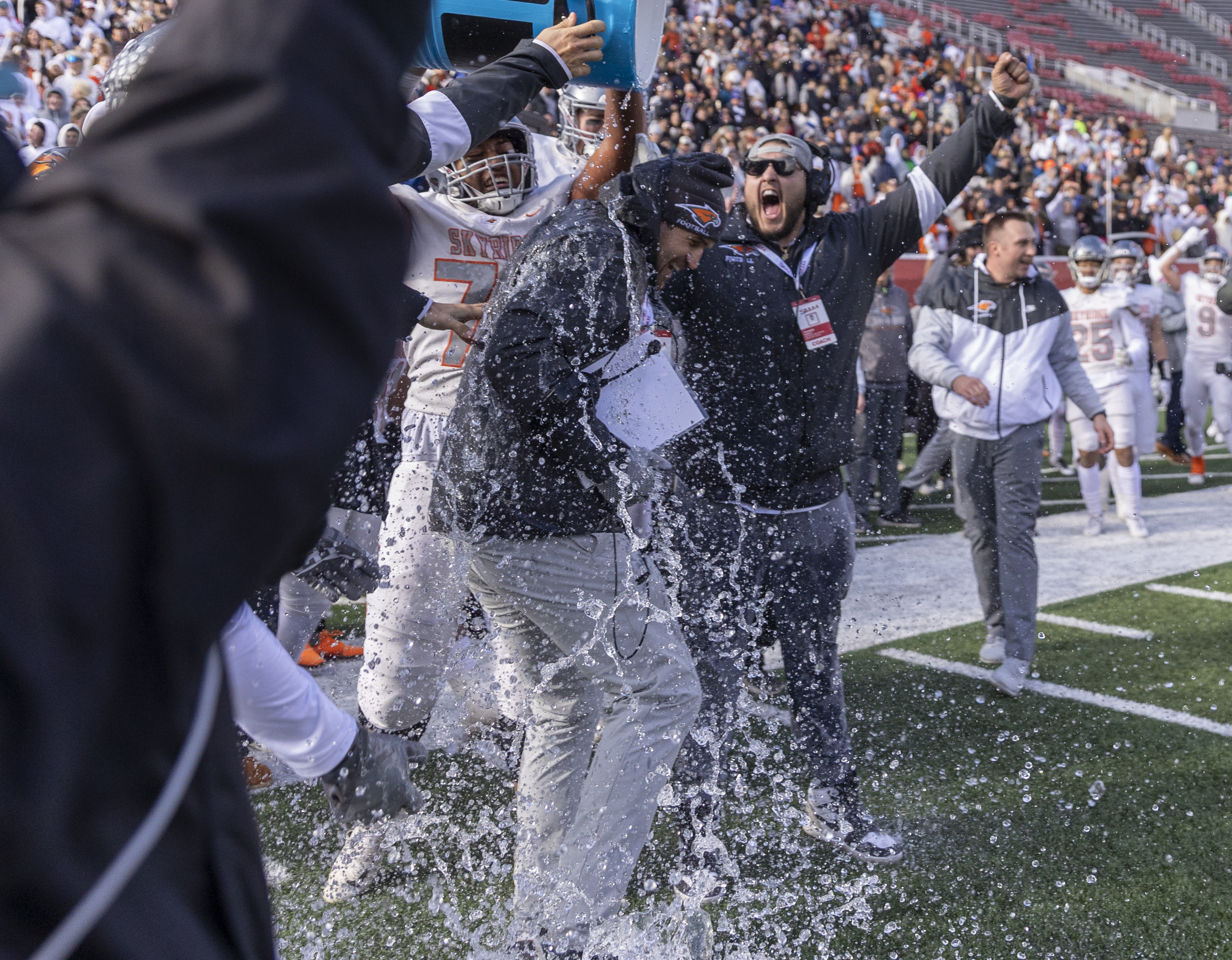 Skyridge Falcons head coach Jon Lehman is doused with one second left as his team plays the Corner Canyon Chargers in the 6A state football championship at Rice-Eccles Stadium at the University of Utah in Salt Lake City on Friday, Nov. 18, 2022. The Falcons won 17-7.