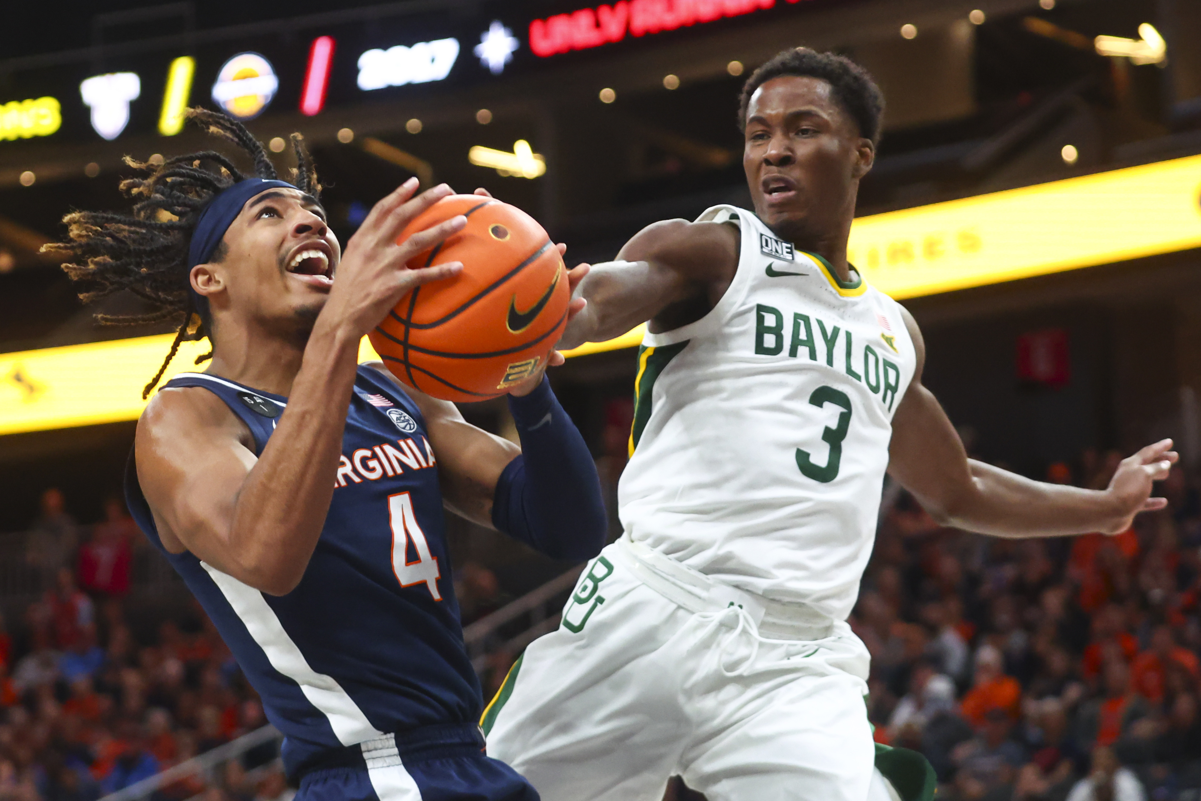 Baylor guard Dale Bonner (3) reaches out to block the shot of Virginia guard Armaan Franklin (4) during the first half of an NCAA college basketball game Friday, Nov. 18, 2022, in Las Vegas. 