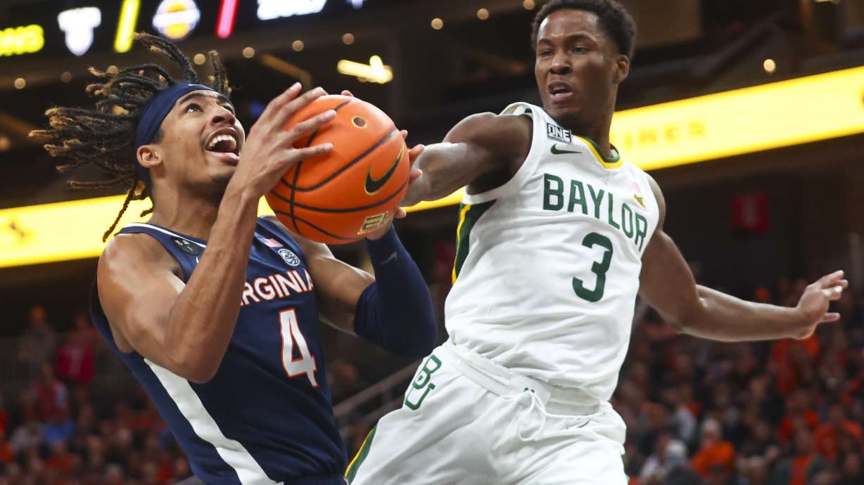 Baylor guard Dale Bonner (3) reaches out to block the shot of Virginia guard Armaan Franklin (4) during the first half of an NCAA college basketball game Friday, Nov. 18, 2022, in Las Vegas.