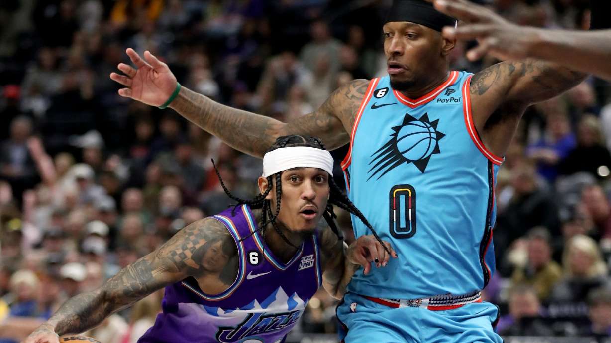 Utah Jazz guard Jordan Clarkson (00) dribbles around Phoenix Suns forward Torrey Craig (0) during an NBA game at the Vivint Arena in Salt Lake City on Friday, Nov. 18, 2022.