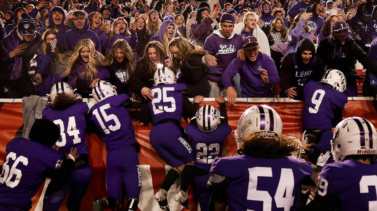 Lehi’s football team runs into the stands after beating Timpview in the 5A state championship game at Rice-Eccles Stadium in Salt Lake City on Friday, Nov. 18, 2022.