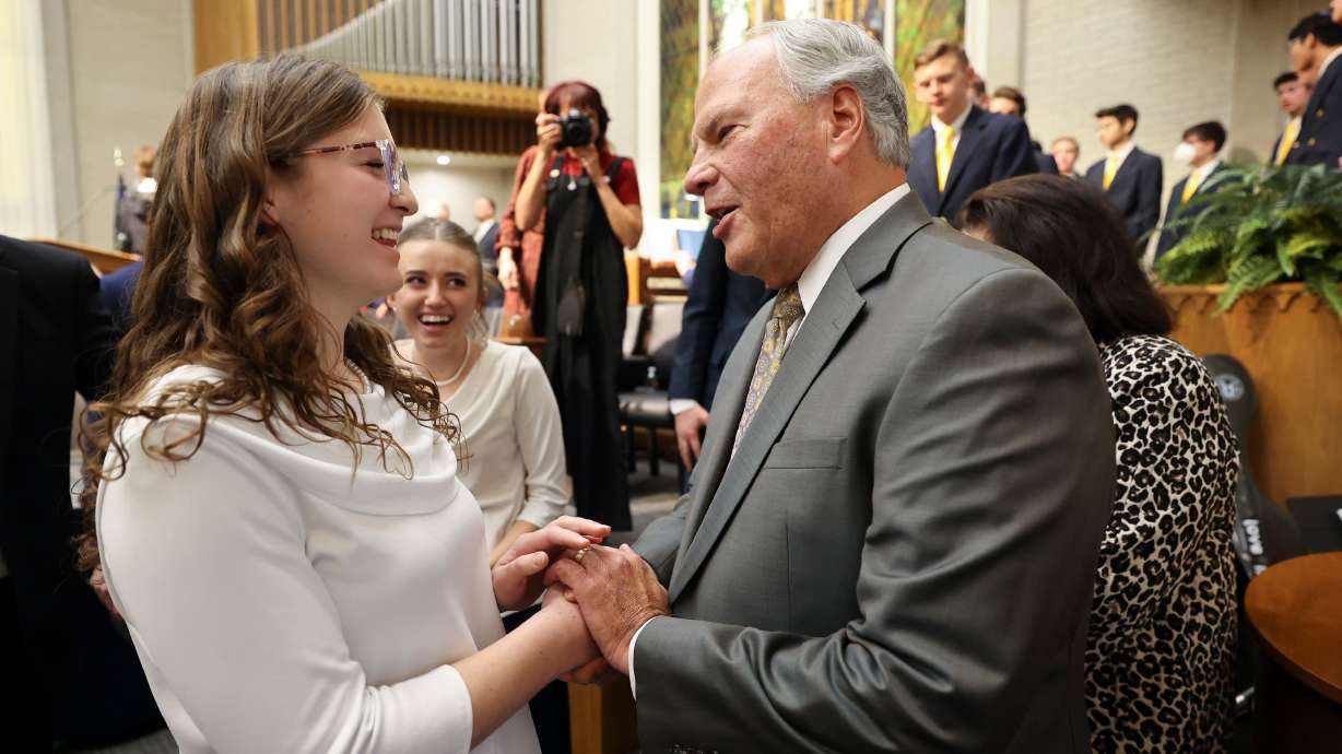 Noelle Pace shakes hands with Elder Ronald A. Rasband of the Quorum of the Twelve Apostles of The Church of Jesus Christ of Latter-day Saints after he dedicated an American Heritage School campus in a former Latter-day Saint meetinghouse leased from the church in Salt Lake City on Friday.