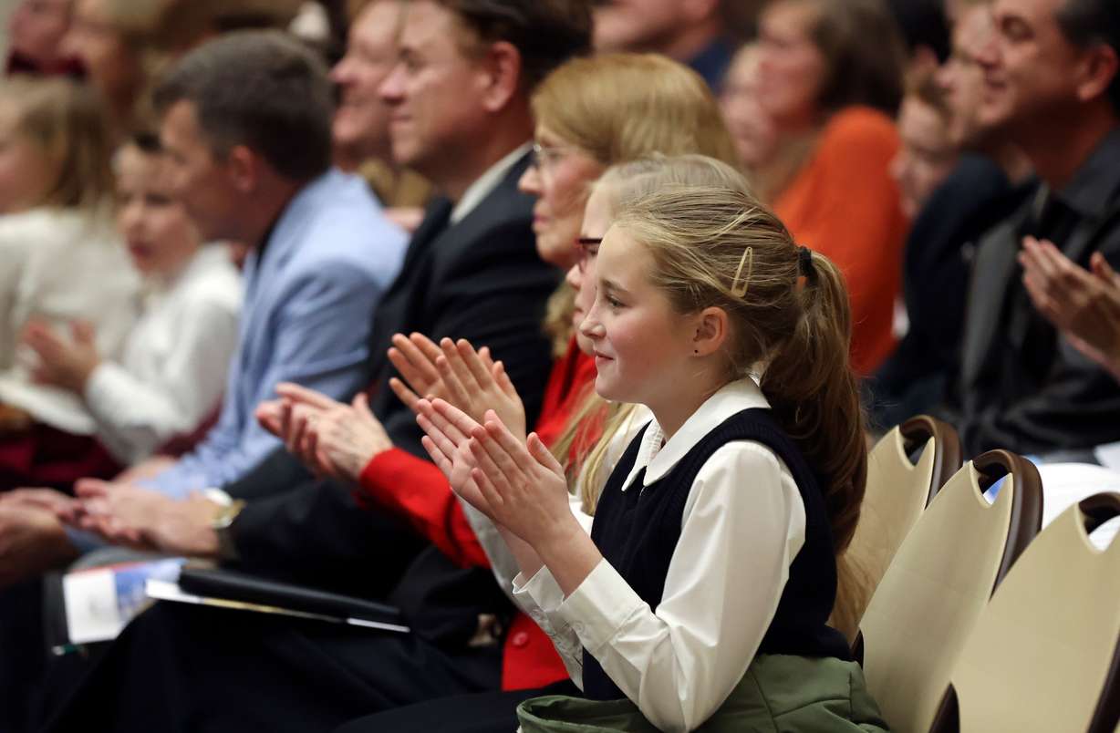 People applaud during a dedication ceremony for an American Heritage School campus in a former Latter-day Saint meetinghouse, leased from The Church of Jesus Christ of Latter-day Saints, in Salt Lake City on Friday.