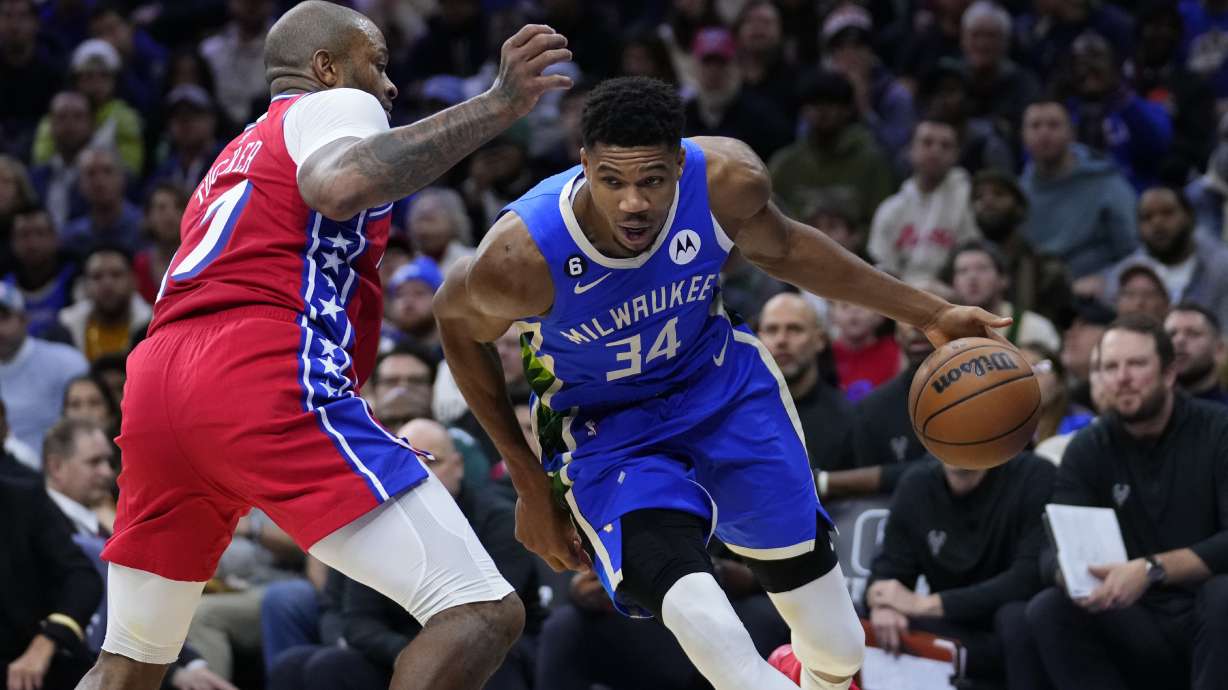 Milwaukee Bucks' Giannis Antetokounmpo, right, tries to get around Philadelphia 76ers' P.J. Tucker during the second half of an NBA basketball game, Friday, Nov. 18, 2022, in Philadelphia.
