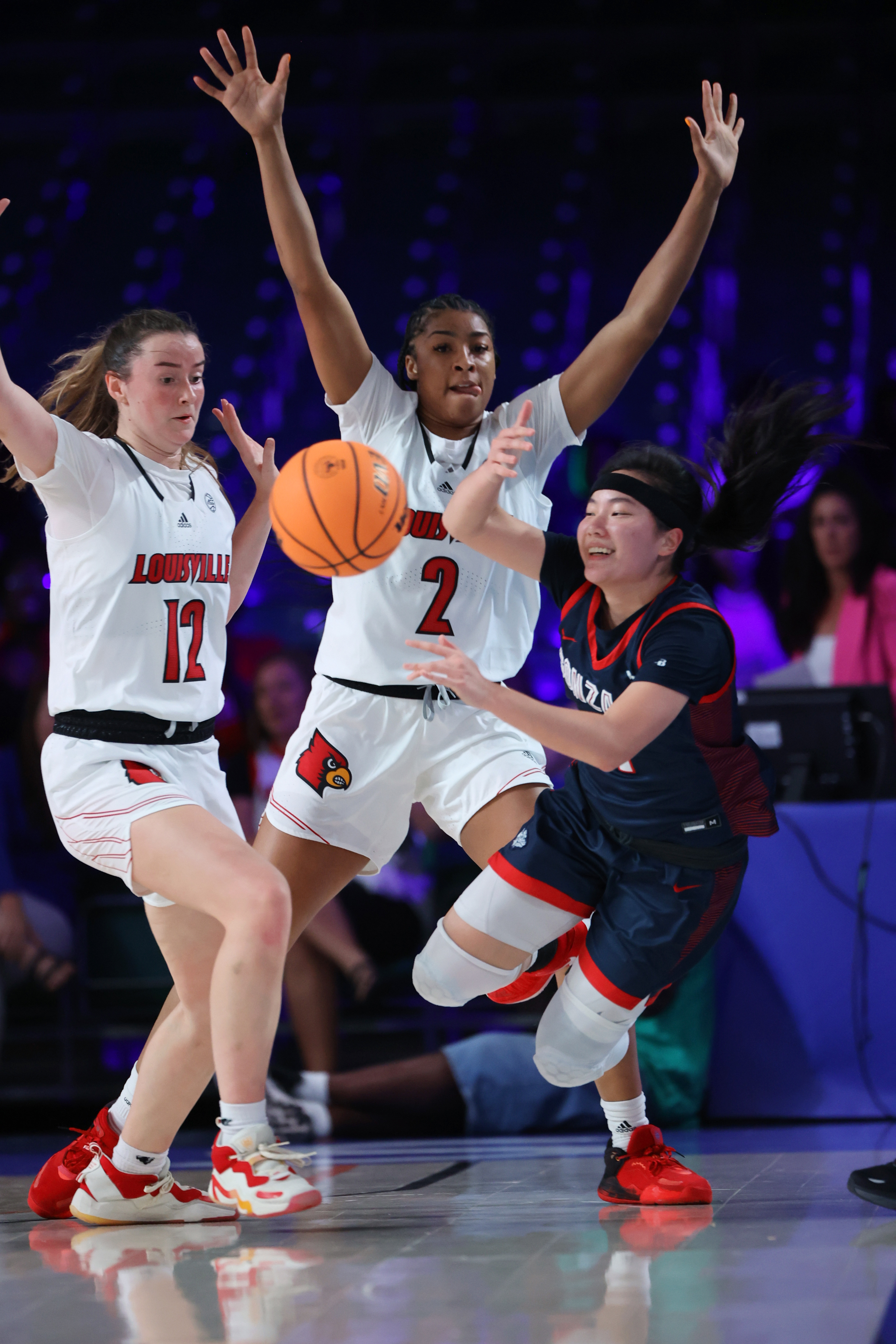 In a photo provided by Bahamas Visual Services, Gonzaga guard Kayleigh Truong, right, is defended by Louisville guard Payton Verhulst, left, and forward Nyla Harris during an NCAA college basketball game in the Battle 4 Atlantis at Paradise Island, Bahamas, Saturday, Nov. 19, 2022. 