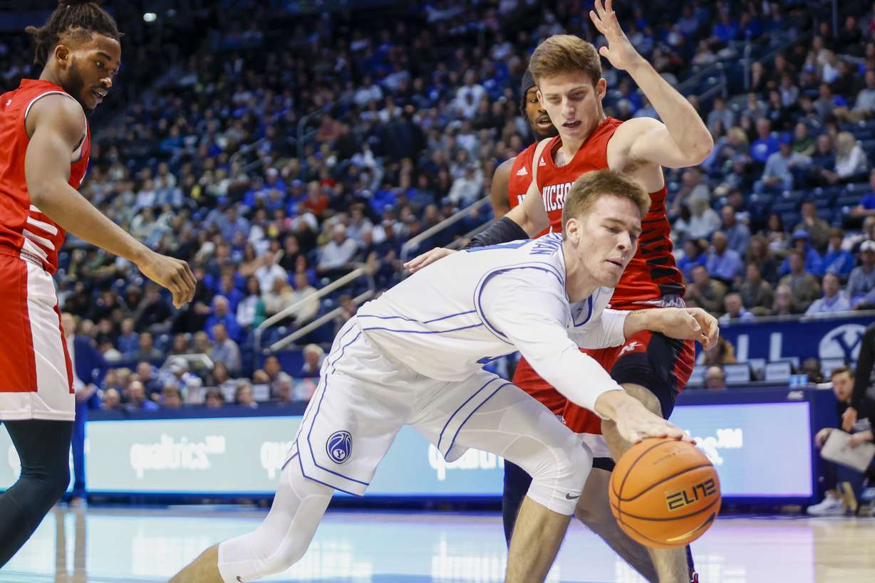 BYU’s Noah Watermann (0) dribbles the ball while being defended by Nicholls' Pierce Spencer (5) at the Marriott Center in Provo on Saturday, Nov. 19, 2022. BYU won 87-73.