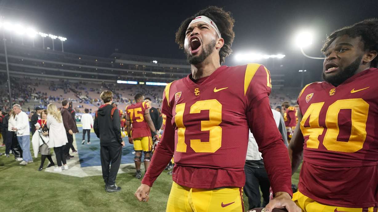 Southern California quarterback Caleb Williams, left, celebrates after USC defeated UCLA 48-45 in an NCAA college football game Saturday, Nov. 19, 2022, in Pasadena, Calif.