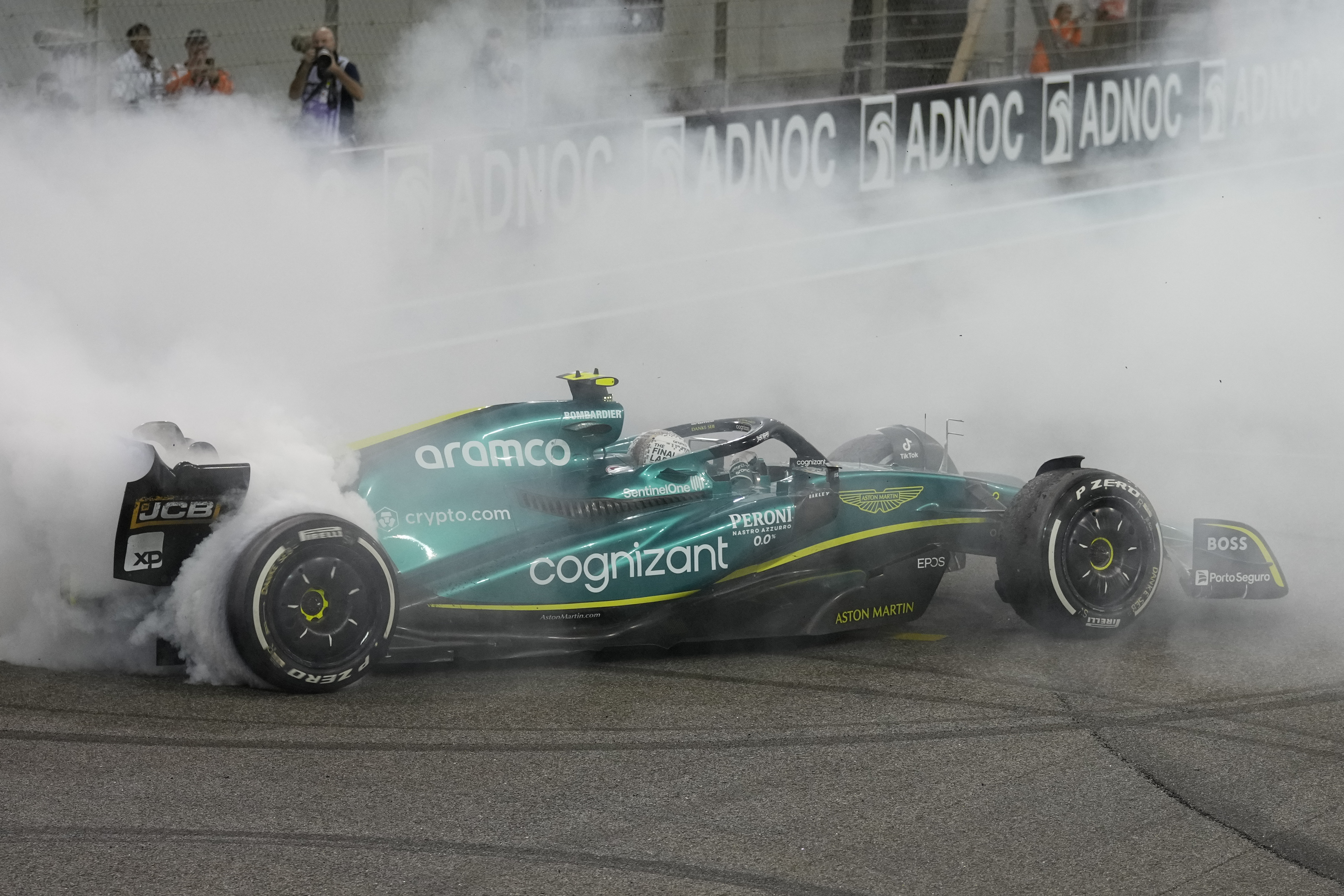 Aston Martin driver Sebastian Vettel of Germany burns the tires as he finished his last race in career at the Formula One Abu Dhabi Grand Prix, in Abu Dhabi, United Arab Emirates Sunday, Nov.20, 2022. 