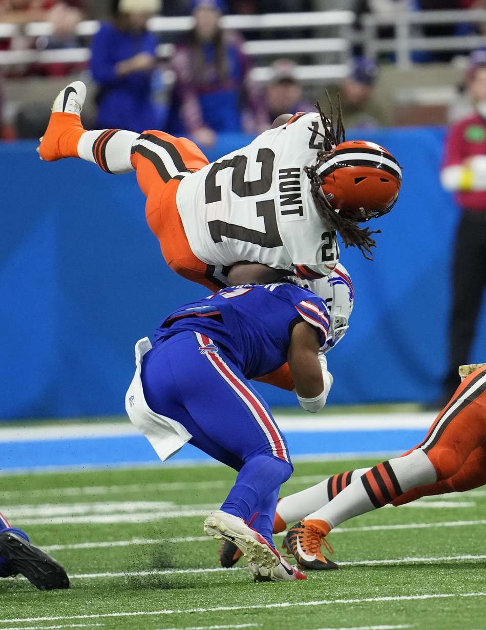 Cleveland Browns running back Kareem Hunt (27) flips over Buffalo Bills cornerback Taron Johnson during the first half of an NFL football game, Sunday, Nov. 20, 2022, in Detroit.