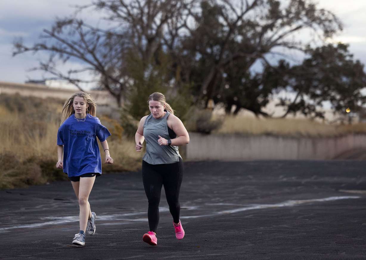 Jody Reid, a mother of three who reversed her Type 2 diabetes through exercise and diet, right, runs with daughter Kaylyn,13, during a fitness class at Roy CrossFit in Roy on Nov. 9.