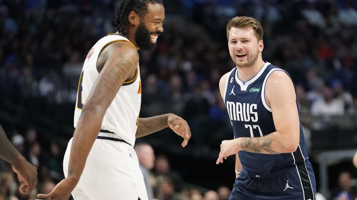 Denver Nuggets center DeAndre Jordan (6) and Dallas Mavericks guard Luka Doncic (77) laugh after they bumped into each other during the first quarter of an NBA basketball game in Dallas, Sunday, Nov. 20, 2022.