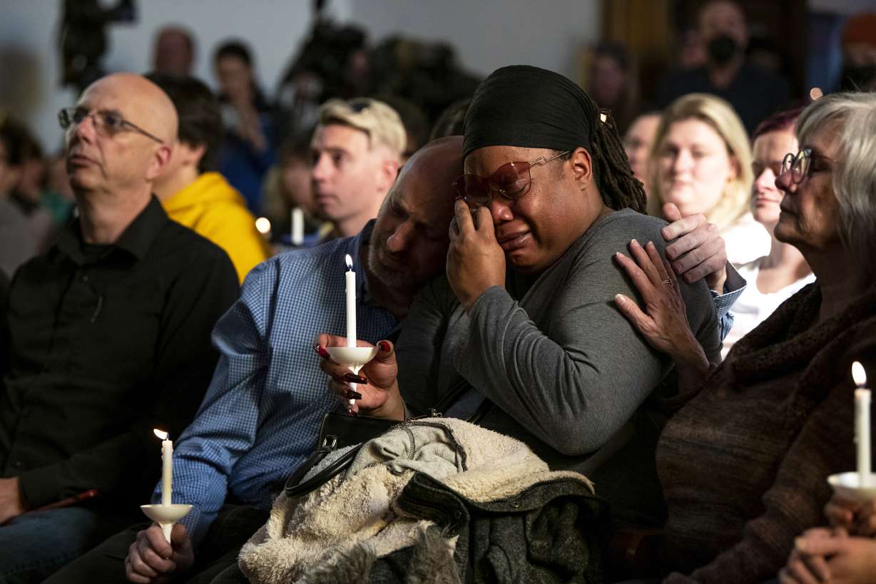 Tyrice Kelley, center right, a performer at Club Q, is comforted during a service held at All Souls Unitarian Church following an overnight fatal shooting at the gay nightclub, in Colorado Springs, Colo., on Sunday.