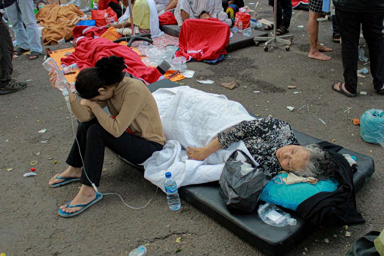 Earthquake survivors are treated outside of a hospital in Cianjur, West Java, Indonesia, Monday. An earthquake shook Indonesia's main island of Java on Monday damaging dozens of buildings and sending residents into the capital's streets for safety.