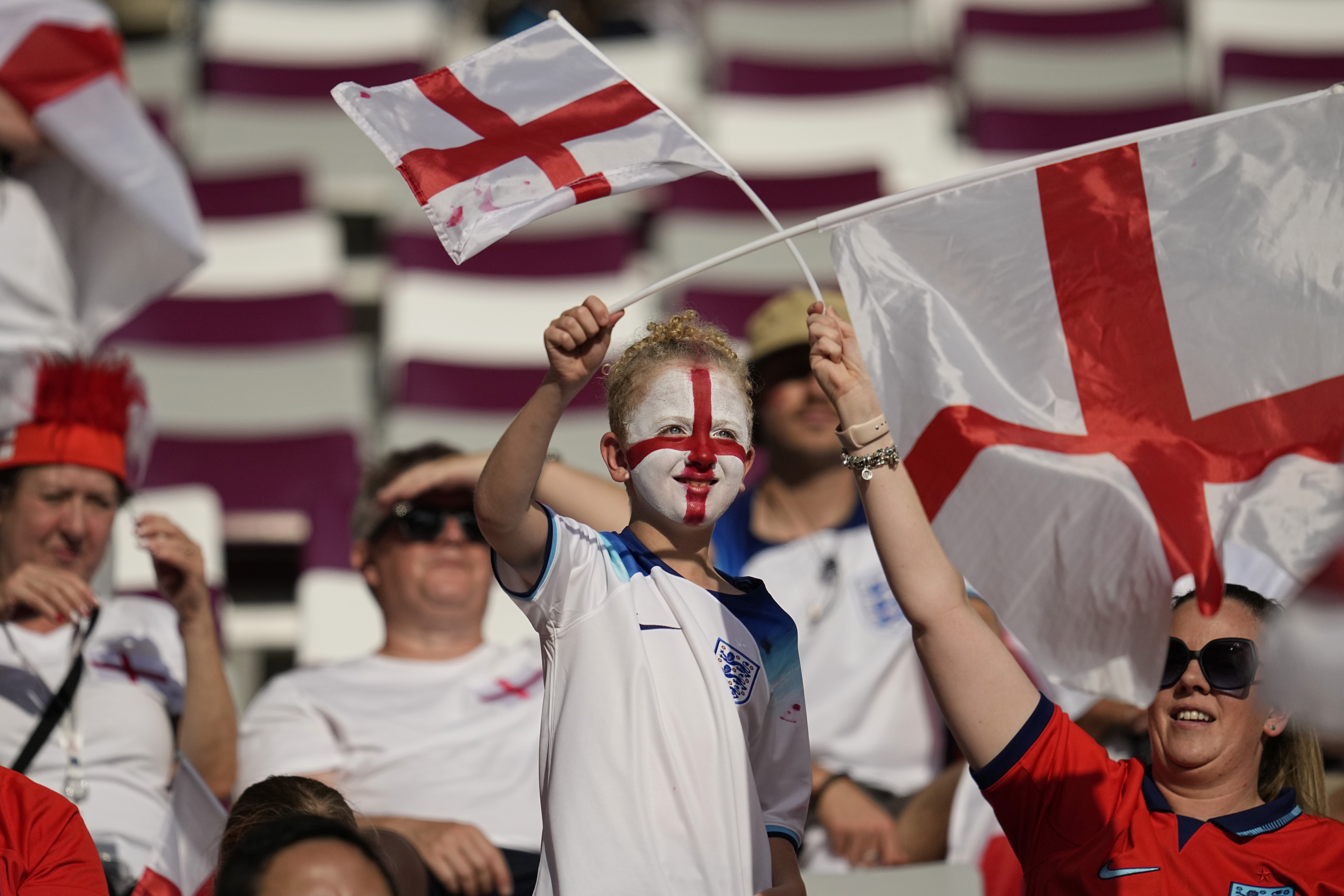Fans wave England flags prior to the start of the World Cup group B soccer match between England and Iran at the Khalifa International Stadium in Doha, Qatar, Monday, Nov. 21, 2022. 