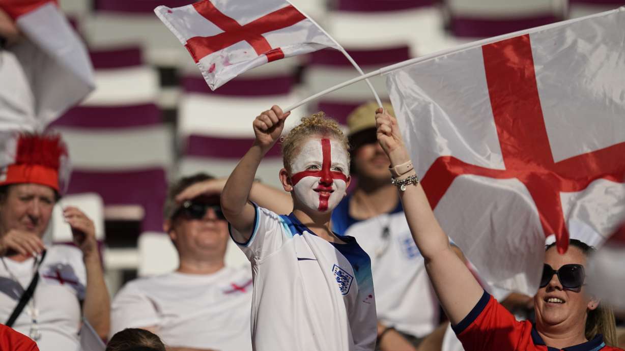Fans wave England flags prior to the start of the World Cup group B soccer match between England and Iran at the Khalifa International Stadium in Doha, Qatar, Monday, Nov. 21, 2022.