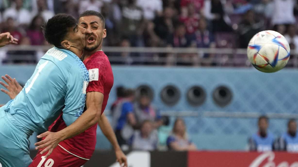Iran's goalkeeper Alireza Beiranvand collides with Iran's Majid Hosseini, right, during the World Cup group B soccer match between England and Iran at the Khalifa International Stadium in Doha, Qatar, Monday, Nov. 21, 2022.