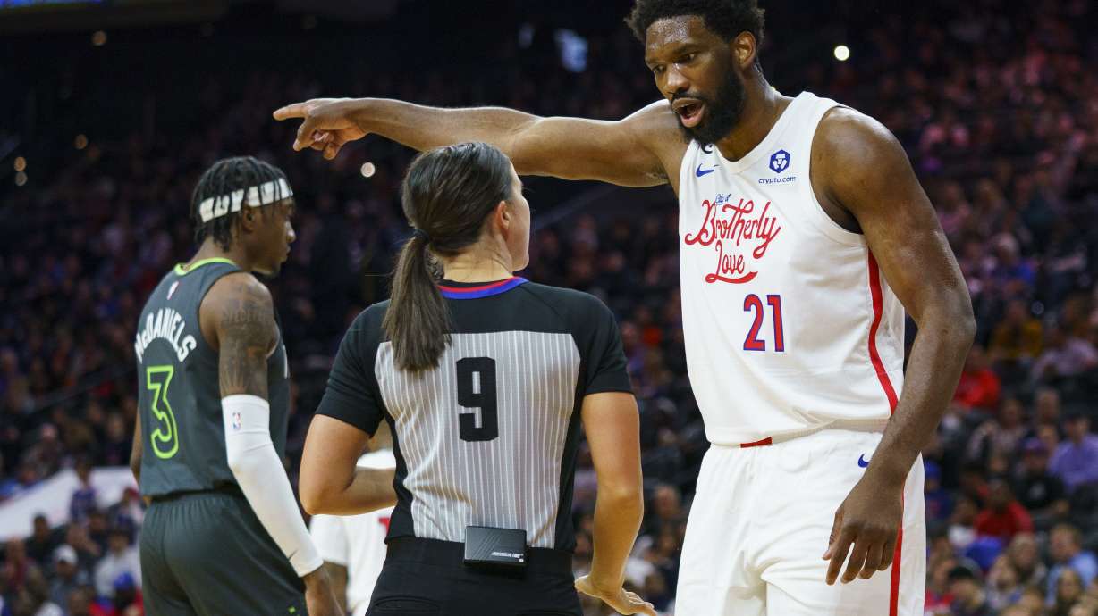 Philadelphia 76ers' Joel Embiid, right, reacts to a call by official Natalie Sago, center, during the first half of an NBA basketball game against the Minnesota Timberwolves, Saturday, Nov. 19, 2022, in Philadelphia.