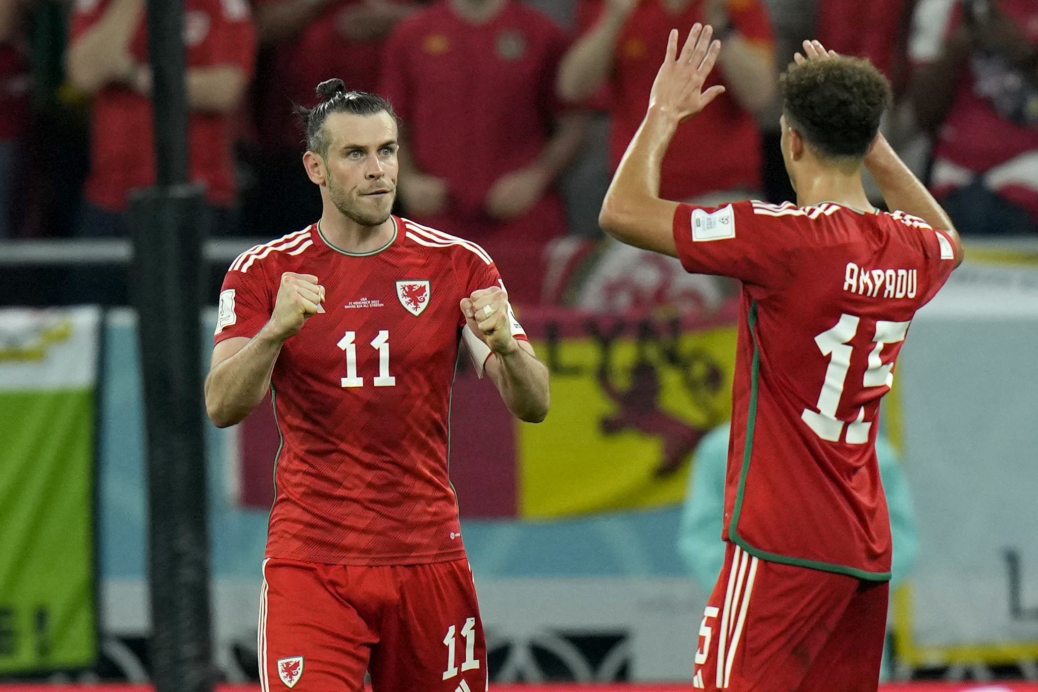 Wales' Gareth Bale celebrates with Ethan Ampadu, right, after scoring his side's first goal from the penalty spot during the World Cup, group B soccer match between the United States and Wales, at the Ahmad Bin Ali Stadium in Doha, Qatar, Monday, Nov. 21, 2022. 