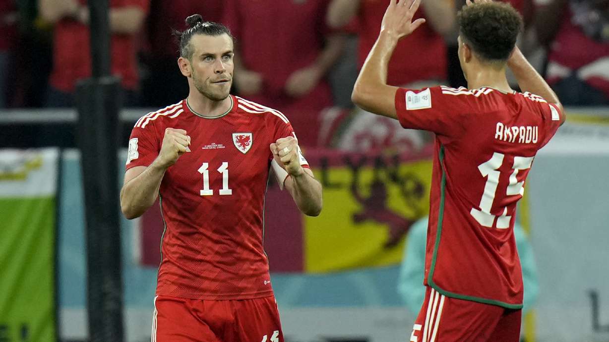 Wales' Gareth Bale celebrates with Ethan Ampadu, right, after scoring his side's first goal from the penalty spot during the World Cup, group B soccer match between the United States and Wales, at the Ahmad Bin Ali Stadium in Doha, Qatar, Monday, Nov. 21, 2022.
