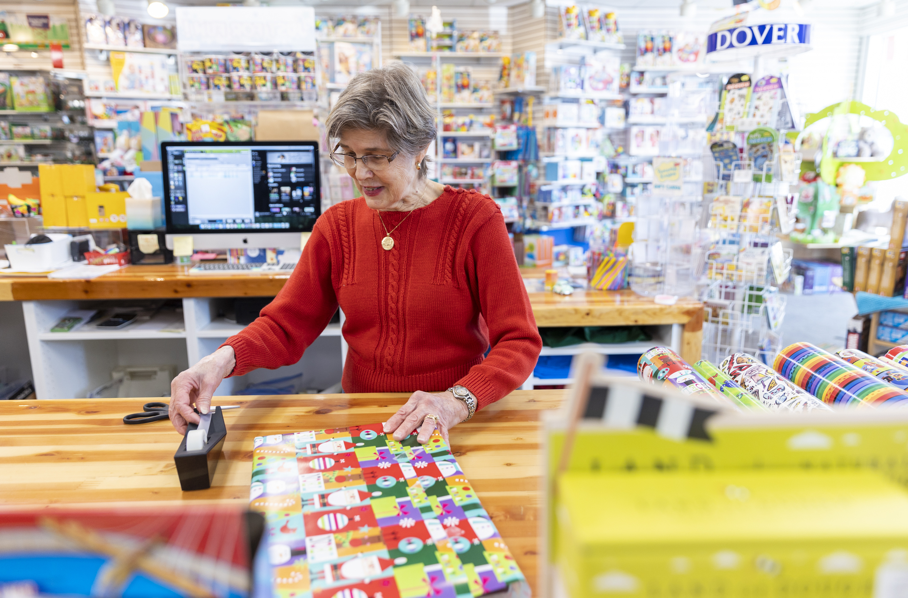 Diane Sartain, co-owner at Tutoring Toy, wraps a present for a customer on Monday in Salt Lake City. The past two years haven't been overly cheery for local businesses struggling through the pandemic and its aftermath, but things appear to be looking up this year amid easing inflation and growing consumer sentiment. 