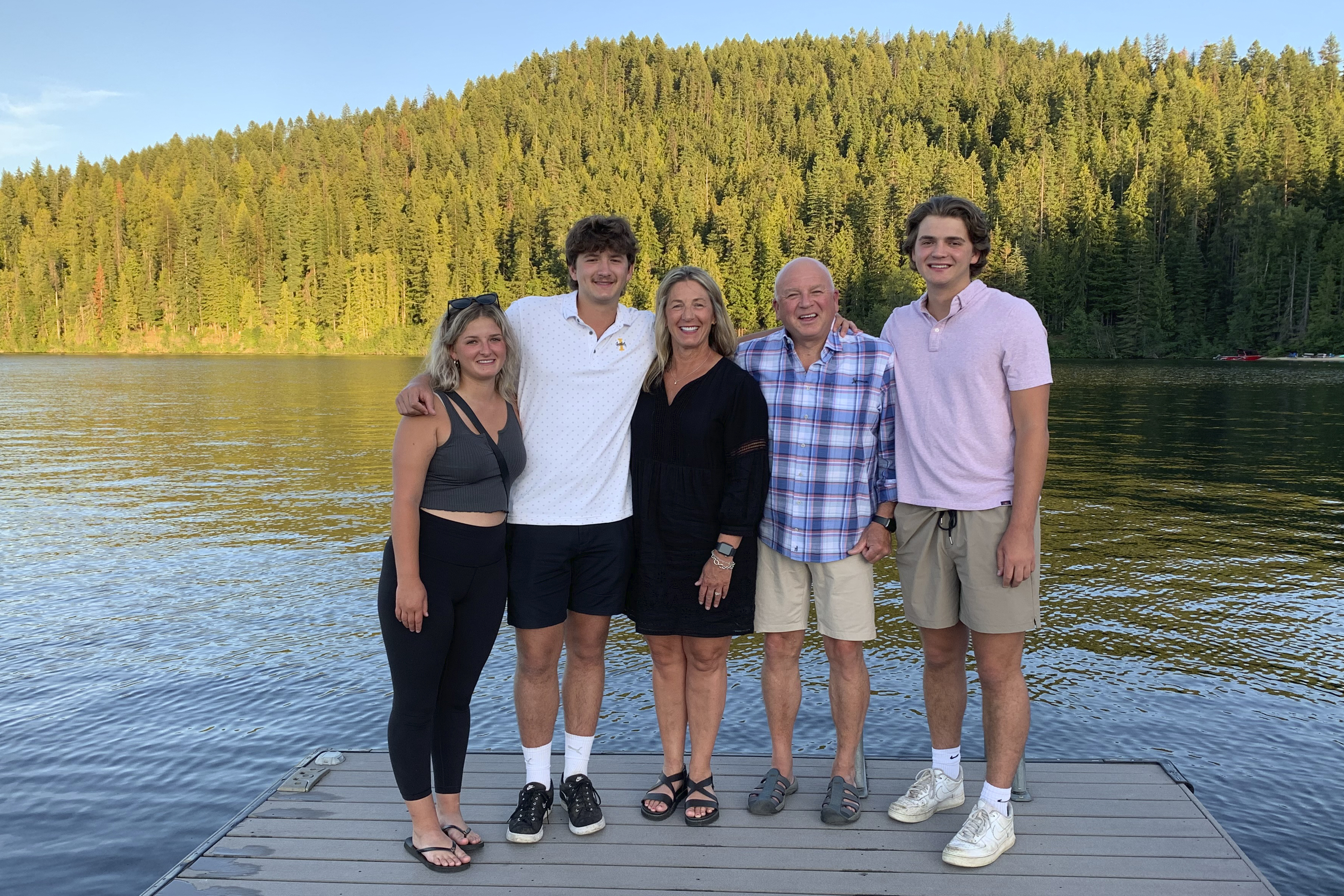 In this photo provided by Stacy Chapin, triplets Maizie, left, Ethan, second from left, and Hunter, right, pose with their parents Stacy and Jim Chapin at Priest Lake in northern Idaho in July. Ethan Chapin was one of four University of Idaho students found stabbed to death in a home near the Moscow, Idaho campus on Nov. 13. 
