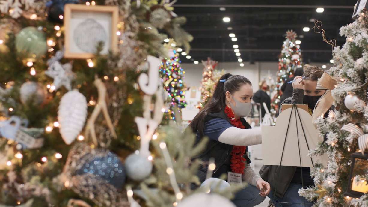 A volunteer sets up a tree during the 2021 Festival of Trees, which was held virtually. The 2022 festival will be the first in-person Festival of Trees since 2019.