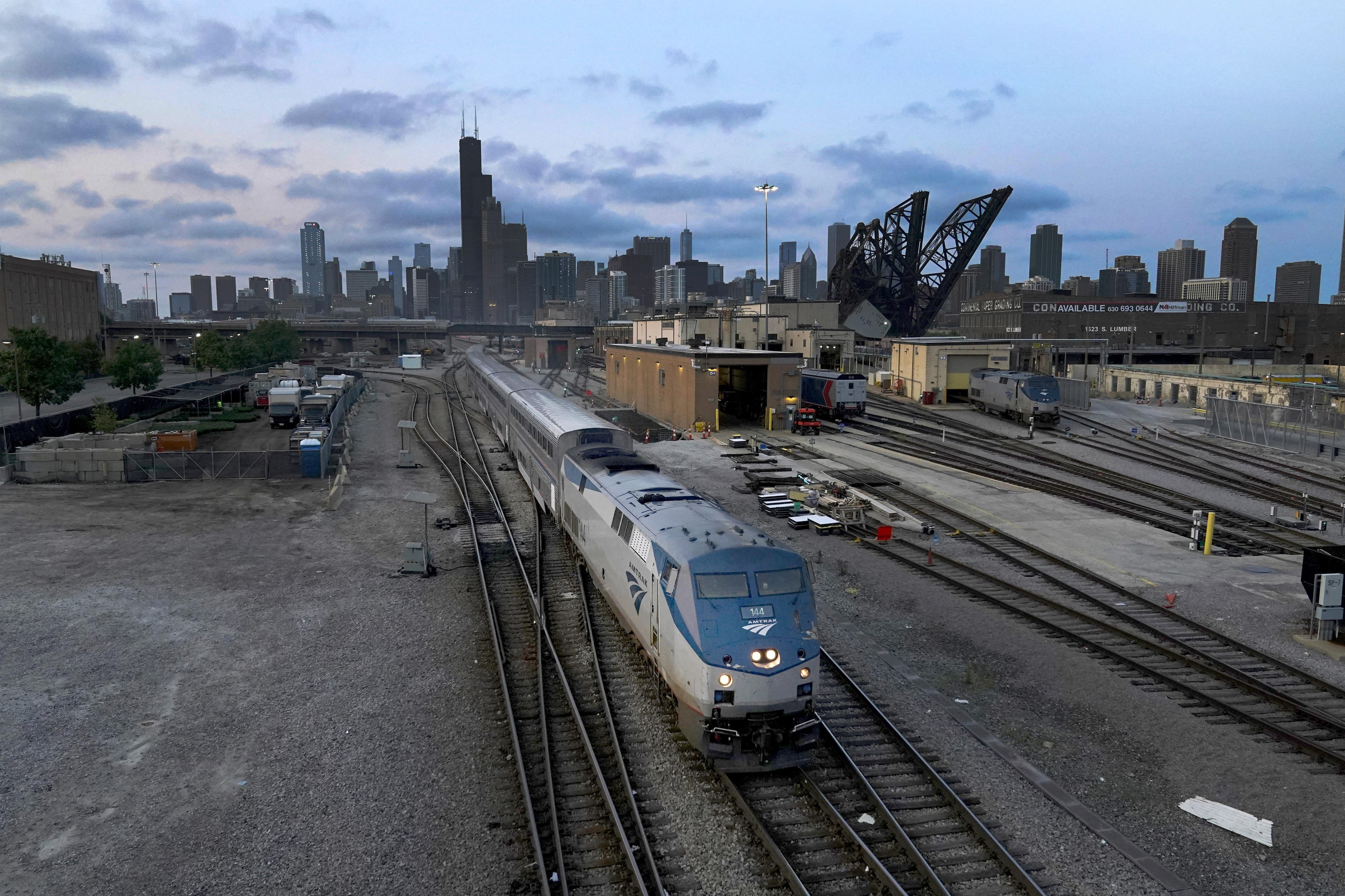 An Amtrak passenger train departs Chicago in the early evening headed south on Sept. 14 in Chicago. American consumers and nearly every industry will be affected if freight trains grind to a halt in December.