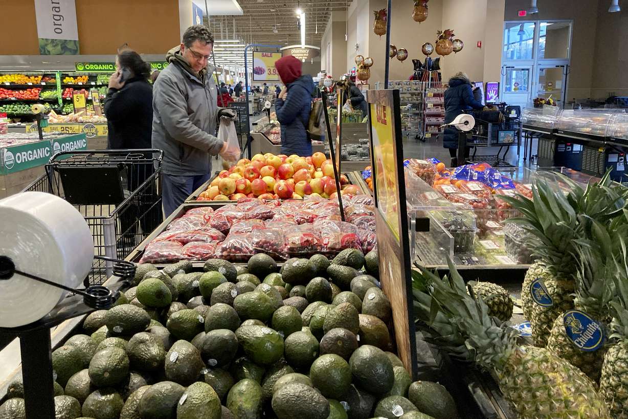 Shoppers pick out items at a grocery store in Glenview, Ill., on Nov. 19. American consumers and nearly every industry will be affected if freight trains grind to a halt in December.