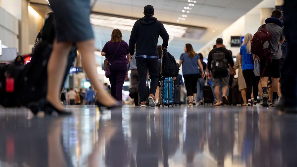 Travelers walk through the Salt Lake City International Airport in Salt Lake City on Aug. 2, 2022. The Federal Aviation Administration announced Monday it is granting $29 million to the airport's Concourse B expansion project, set to be complete in 2027.