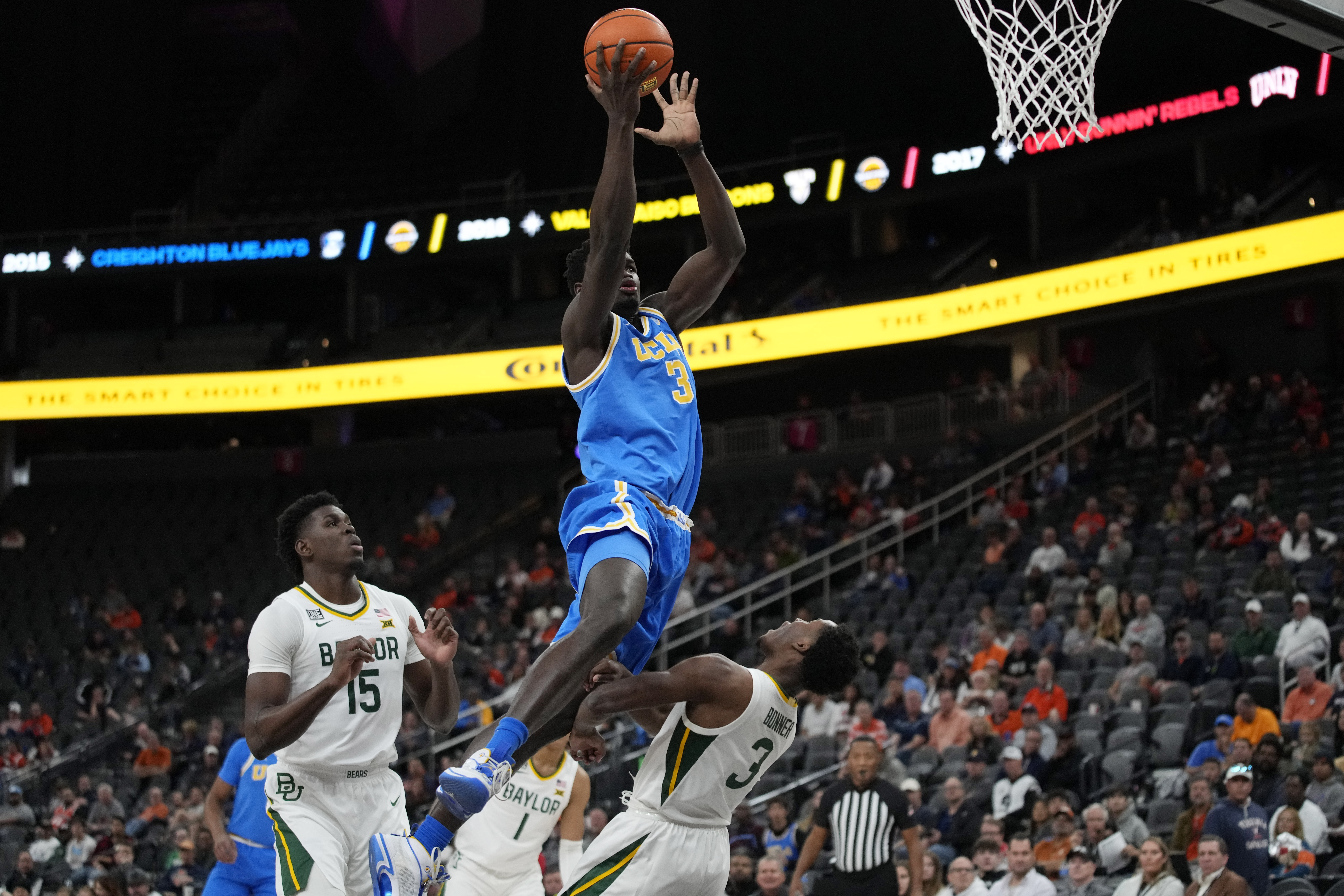 UCLA's Adem Bona, left, fouls Baylor's Dale Bonner during the first half of an NCAA college basketball game Sunday, Nov. 20, 2022, in Las Vegas. 