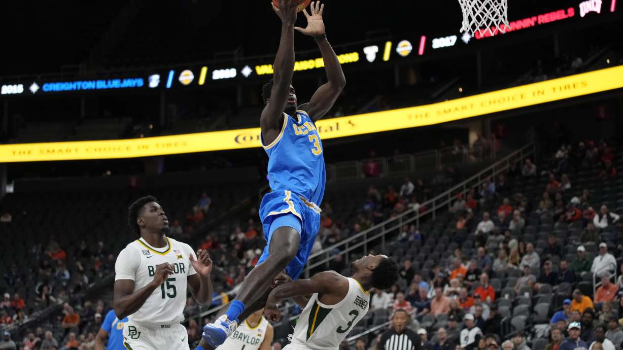 UCLA's Adem Bona, left, fouls Baylor's Dale Bonner during the first half of an NCAA college basketball game Sunday, Nov. 20, 2022, in Las Vegas.