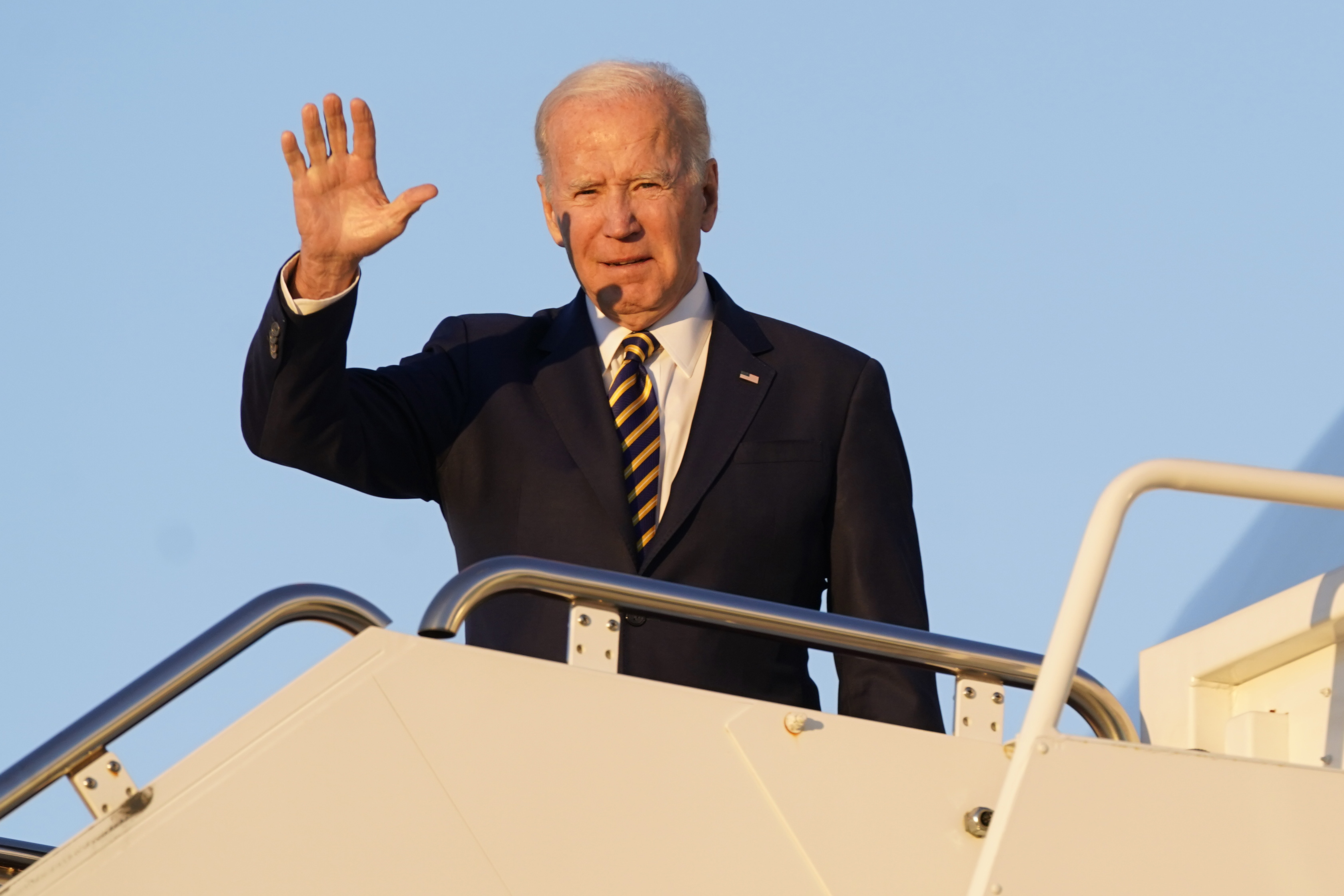 President Joe Biden waves as he boards Air Force One, Monday at Andrews Air Force Base, Md. Biden's administration will extend the pause on federal student loan payments while the White House fights a legal battle to save his plan to cancel portions of the debt.